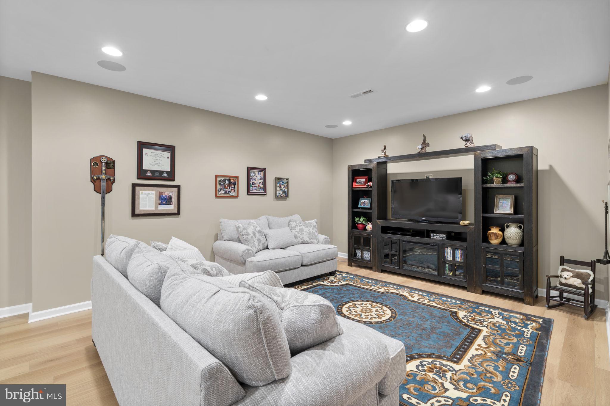 9323 Castle Hill Road Springfield, VA 22153 - Photo 70 of 95 a living room with furniture and a flat screen tv