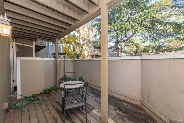 a backyard of a house with table and chairs