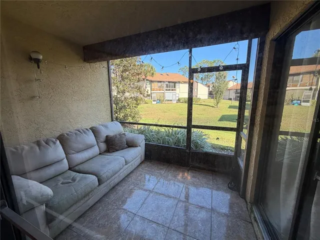 a living room with furniture and a floor to ceiling window