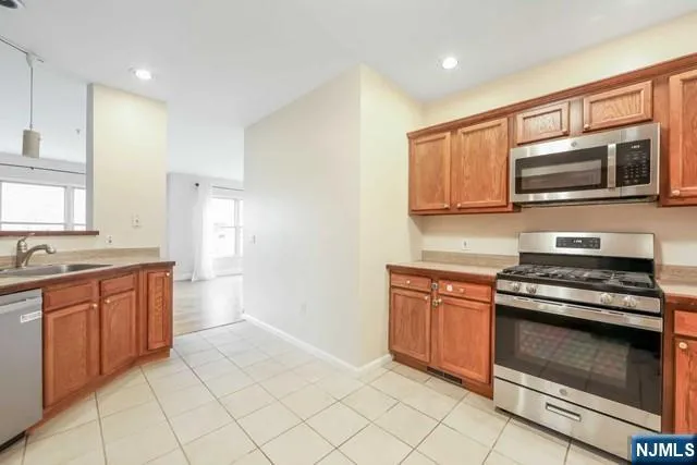 a kitchen with a sink refrigerator and cabinets
