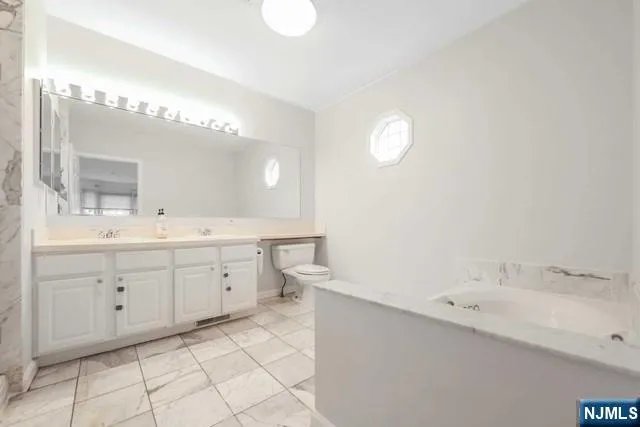 a view of bathroom with a toilet sink and a mirror