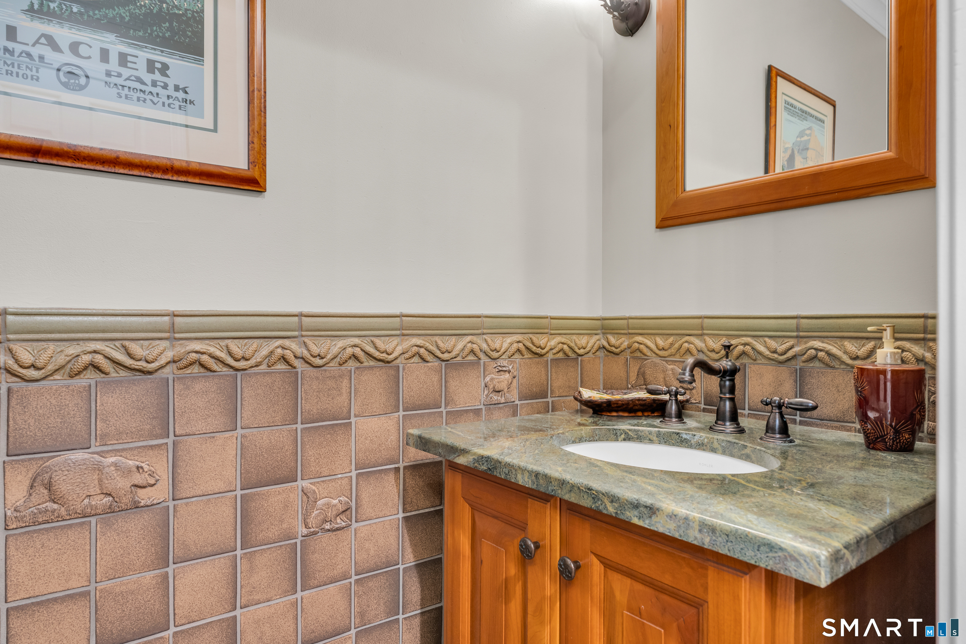 46 Laurel Cliffs Road Guilford, CT 06437 - Photo 13 of 40 The formal Powder Room is located in the hall between the Foyer and the Family Room. Notice the fanciful custom tiles.