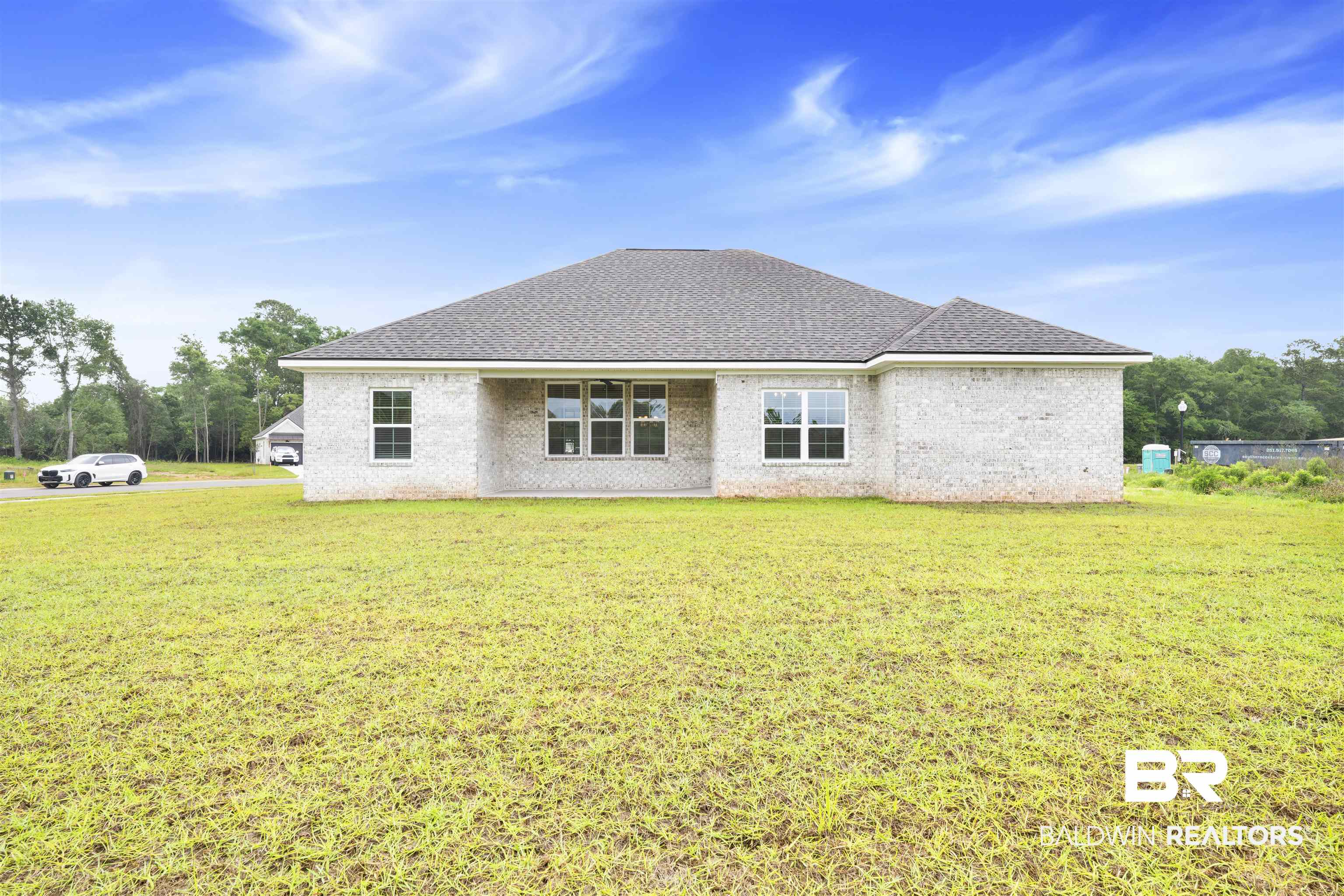 27371 Patch Pl Loop Daphne, AL 36526 - Photo 63 of 63 Rear exterior of a single-story residence with light-colored brick siding and a dark shingle roof