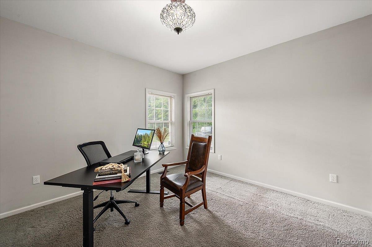 5035 Hidden Ridge Road Metamora, MI 48455 - Photo 7 of 62 Carpeted room featuring light gray walls, two windows, and an ornamental ceiling light fixture