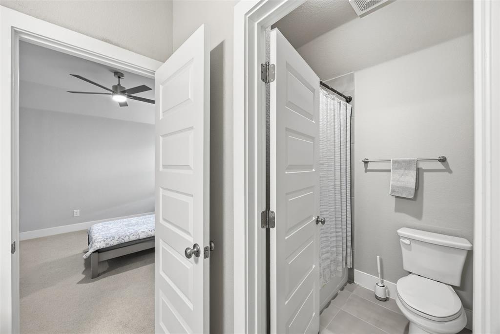 5805 Heatherwood Loop Sachse, TX 75048 - Photo 34 of 39 a bathroom with a toilet a sink and a mirror