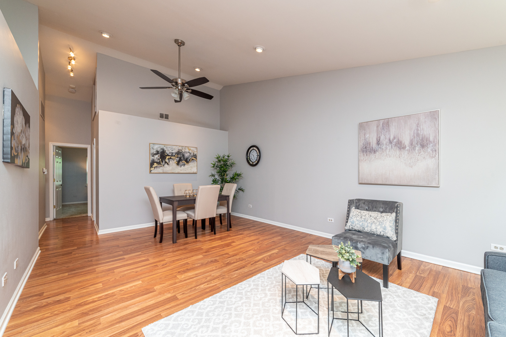 350 Chaparral Circle Elgin, IL 60120 - Photo 12 of 28 a dining room with wooden floor a chandelier a wooden table and chairs