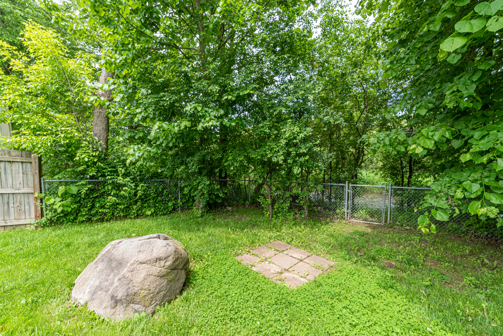 350 Chaparral Circle Elgin, IL 60120 - Photo 26 of 28 a backyard of a house with lots of green space and fountain
