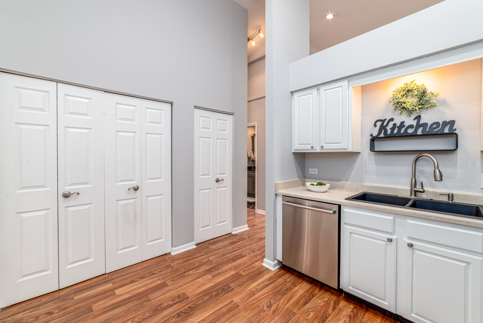 350 Chaparral Circle Elgin, IL 60120 - Photo 5 of 28 a kitchen with stainless steel appliances granite countertop a stove a sink and white cabinets with wooden floor
