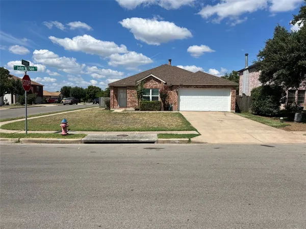 a view of a house with a big yard and large tree