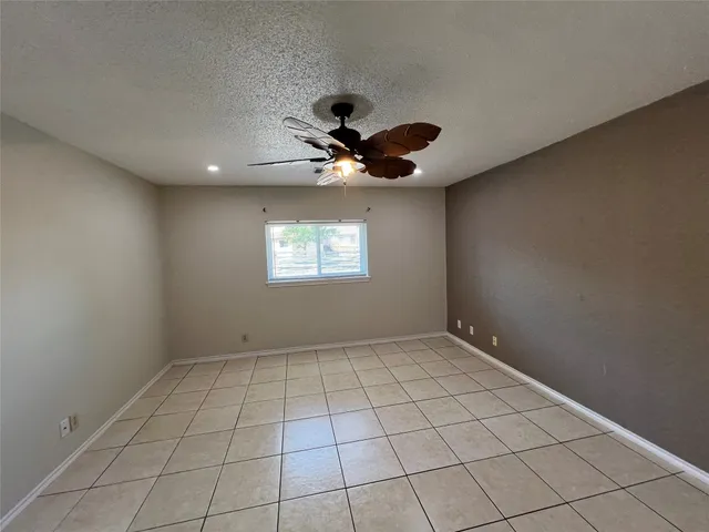 a view of a yard with wooden fence and a large tree