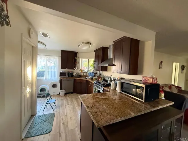 a kitchen with a stove a refrigerator and a dining table