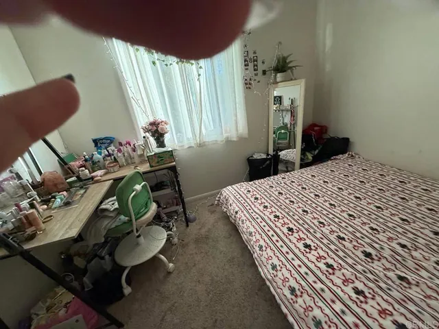 a bedroom with bed and wooden floor