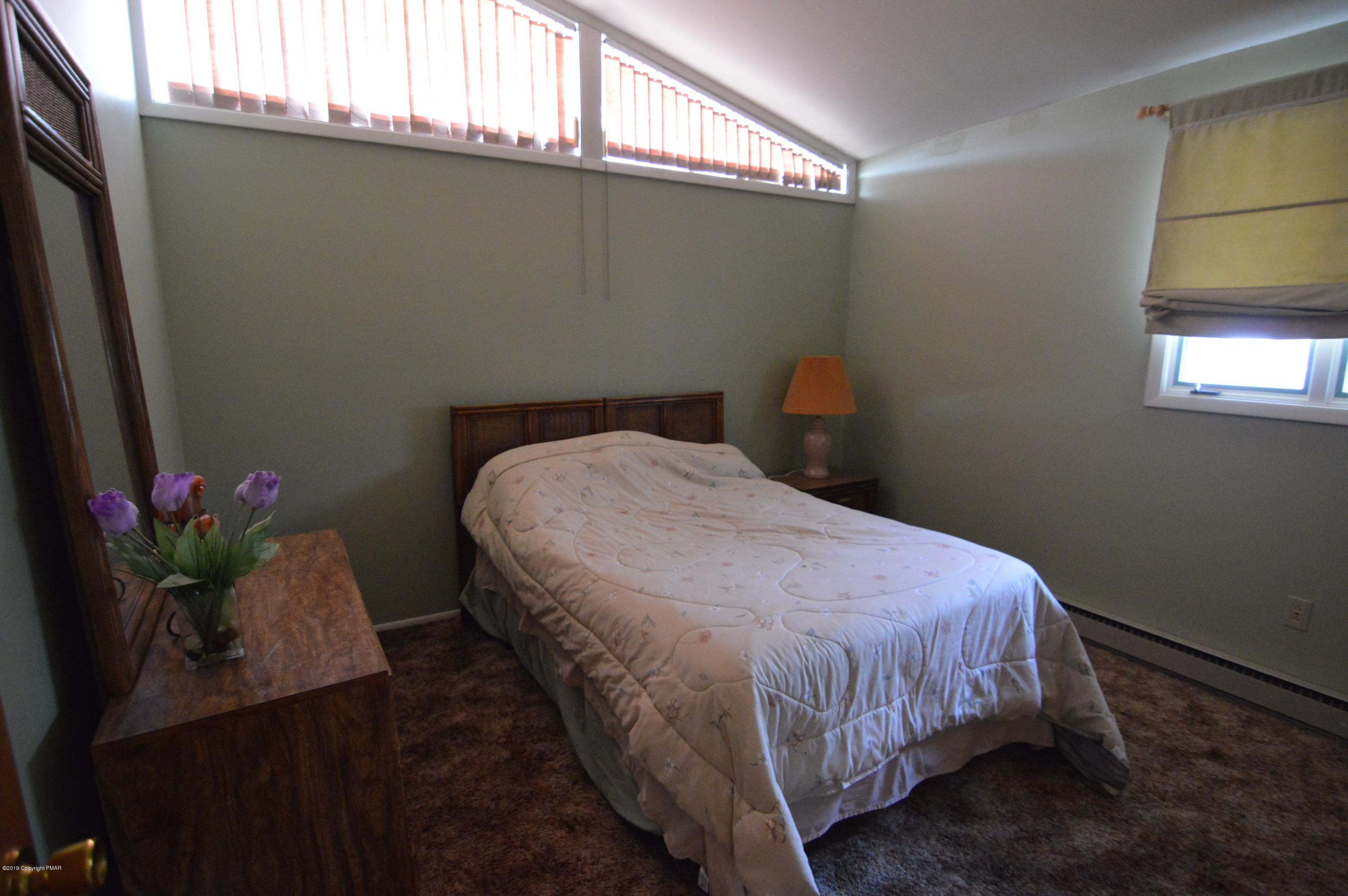 139 Maple Road Blakeslee, PA 18610 - Photo 12 of 29 a bed sitting in a bedroom next to a window