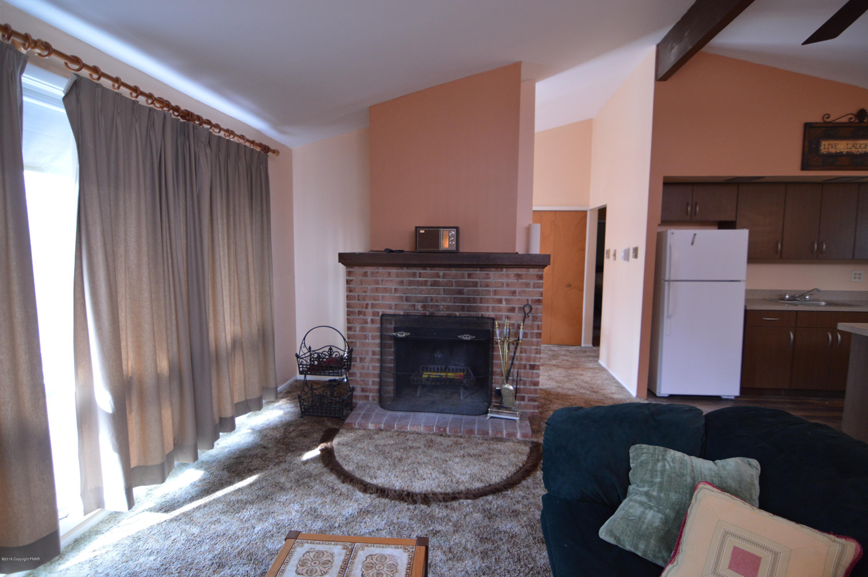 139 Maple Road Blakeslee, PA 18610 - Photo 7 of 29 a living room with furniture and a fireplace