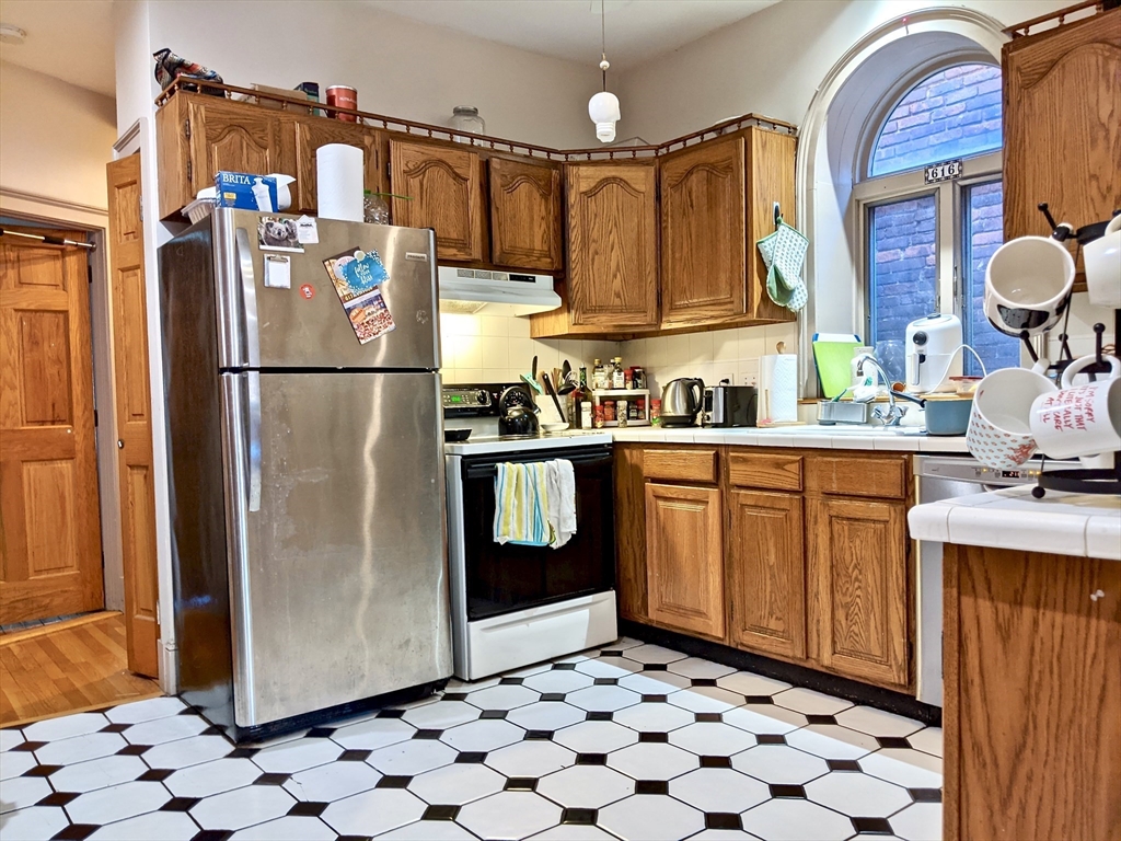 616 Columbus Avenue, Unit 7 Boston, MA 02118 - Photo 12 of 25 a kitchen with stainless steel appliances a refrigerator and a stove top oven