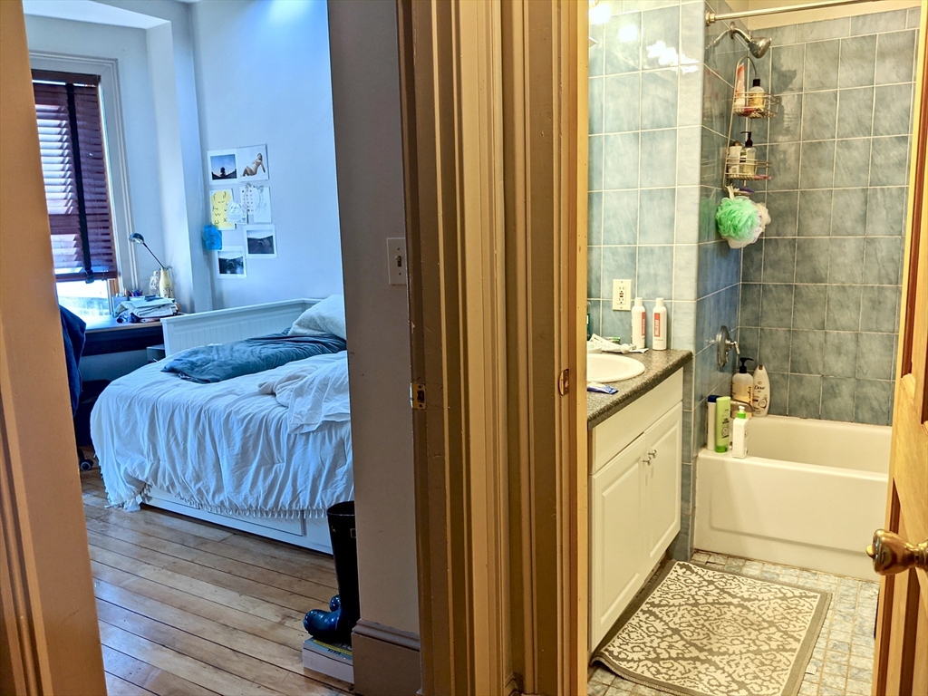 616 Columbus Avenue, Unit 7 Boston, MA 02118 - Photo 16 of 25 a bathroom with a bathtub and shower