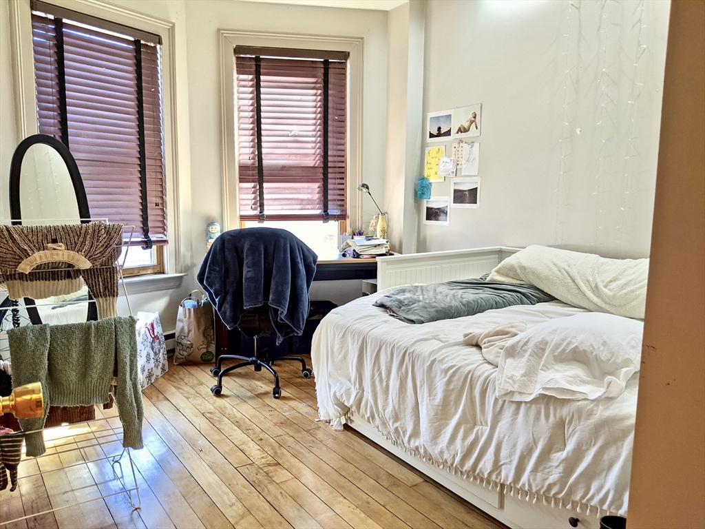 616 Columbus Avenue, Unit 7 Boston, MA 02118 - Photo 17 of 25 a bedroom with two beds and wooden floor