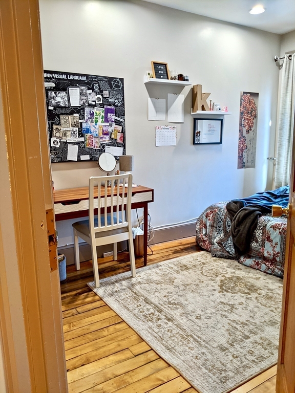 616 Columbus Avenue, Unit 7 Boston, MA 02118 - Photo 18 of 25 a bed room with a bed and a chair