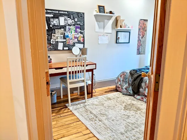 a bed sitting in a bedroom next to a window