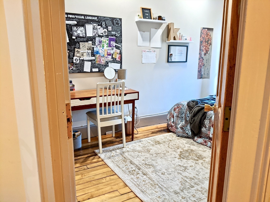 616 Columbus Avenue, Unit 7 Boston, MA 02118 - Photo 19 of 25 a bedroom with a bed and a bookshelf