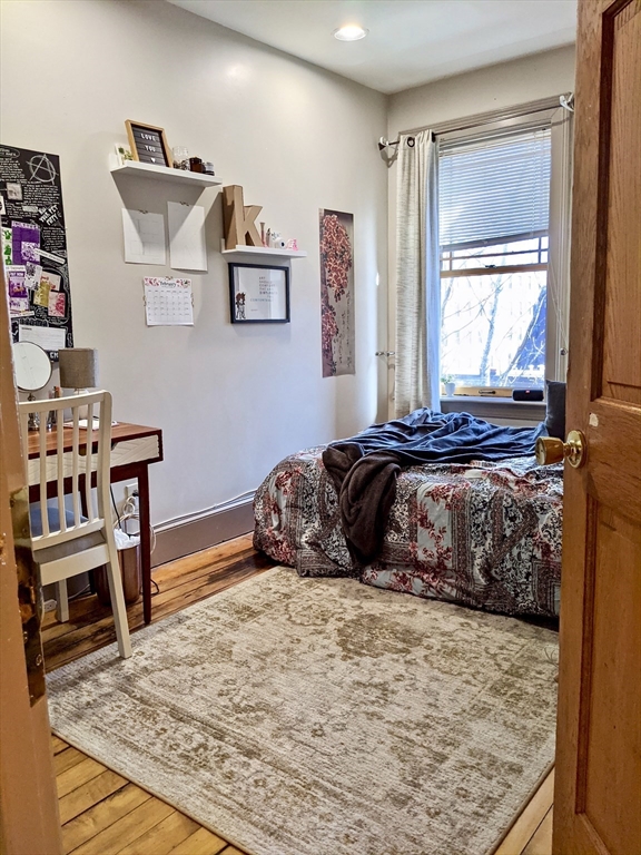 616 Columbus Avenue, Unit 7 Boston, MA 02118 - Photo 21 of 25 a bedroom with a bed and wooden floor