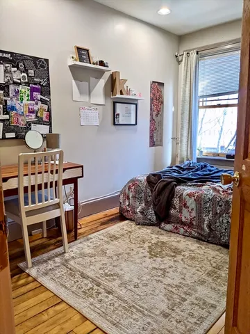 a bedroom with two beds and a table