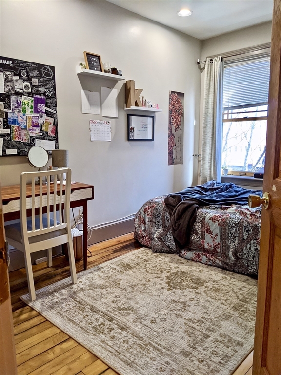 616 Columbus Avenue, Unit 7 Boston, MA 02118 - Photo 22 of 25 a bedroom with a bed a bookshelf and a window