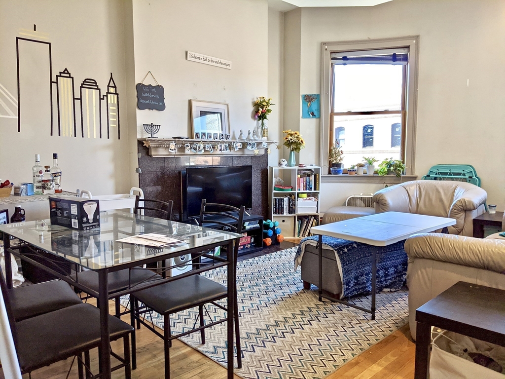 616 Columbus Avenue, Unit 7 Boston, MA 02118 - Photo 4 of 25 a living room with furniture a fireplace and a flat screen tv