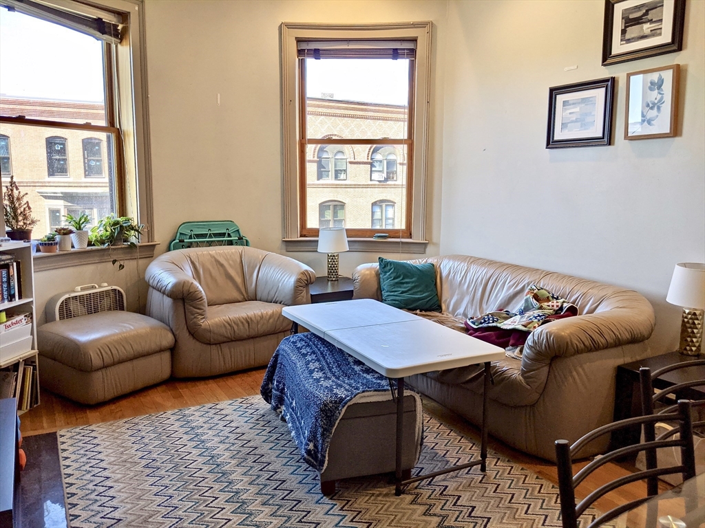 616 Columbus Avenue, Unit 7 Boston, MA 02118 - Photo 6 of 25 a living room with furniture ceiling fan and a window