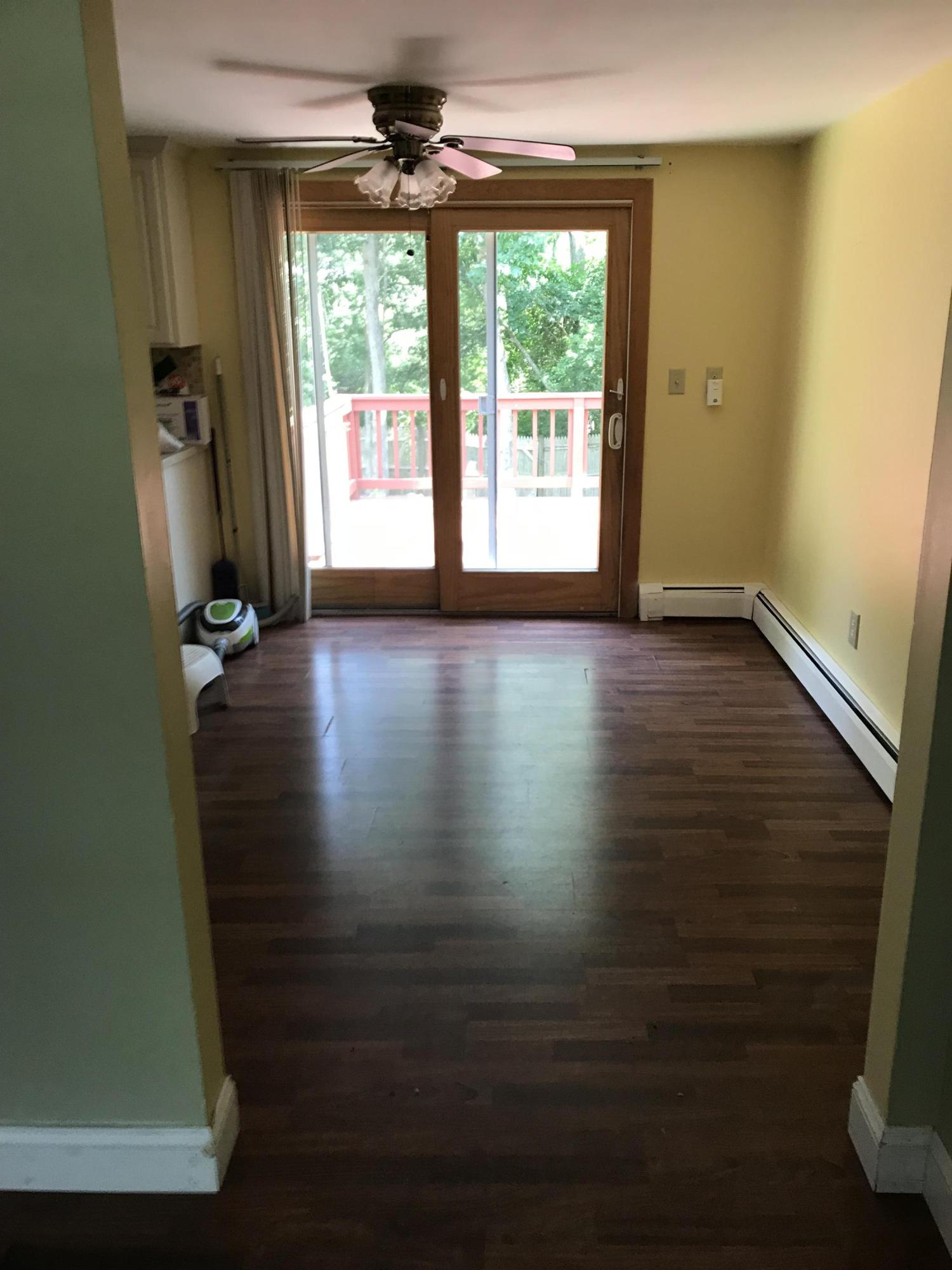 18 Stoney Cliff Road Centerville, MA 02632 - Photo 3 of 14 an empty room with wooden floor and windows