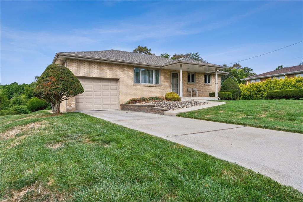 2480 Lynnrose Drive Irwin, PA 15642 - Photo 2 of 39 a front view of a house with a garden and yard