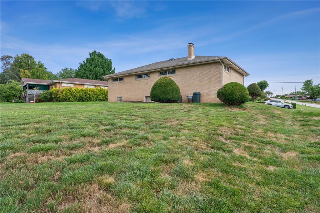 2480 Lynnrose Drive Irwin, PA 15642 - Photo 32 of 39 a view of a backyard with plants and large trees
