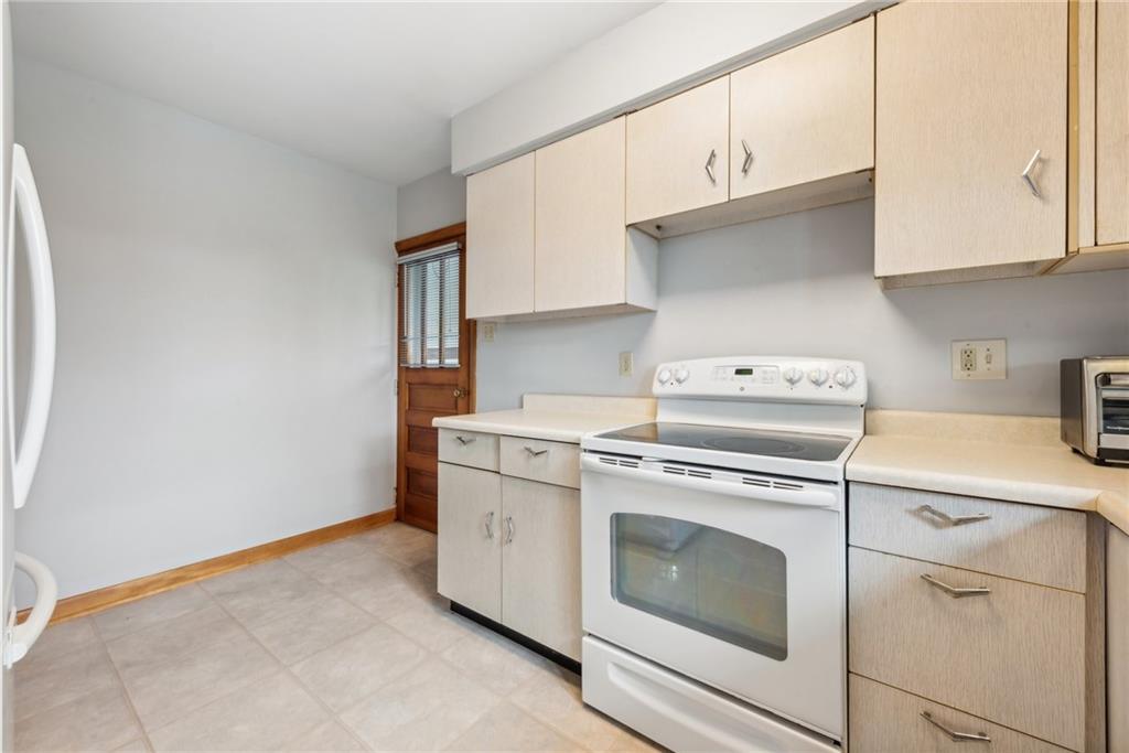 2480 Lynnrose Drive Irwin, PA 15642 - Photo 4 of 39 a kitchen with cabinets appliances washer and dryer