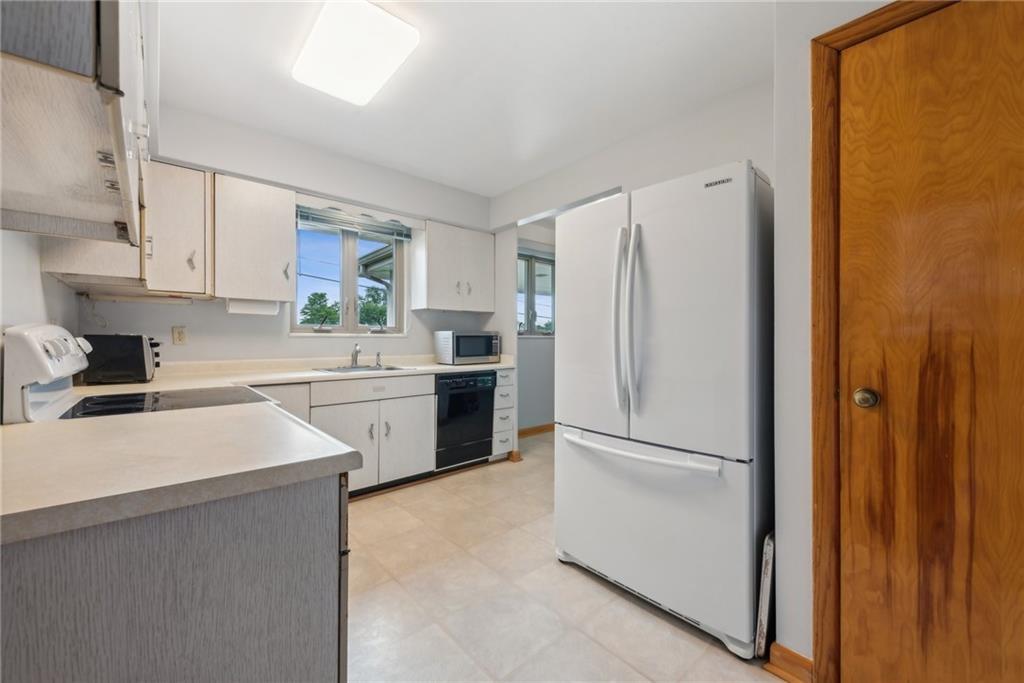 2480 Lynnrose Drive Irwin, PA 15642 - Photo 5 of 39 a kitchen with a refrigerator sink stove and cabinets