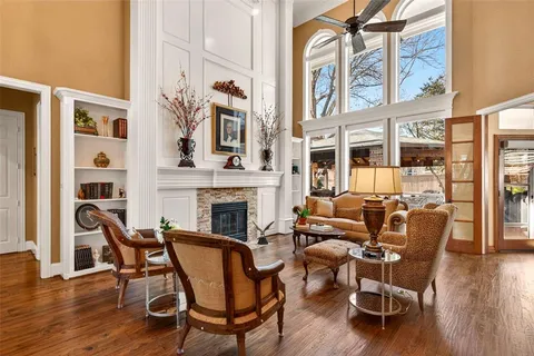 a living room with furniture a fireplace and wooden floor