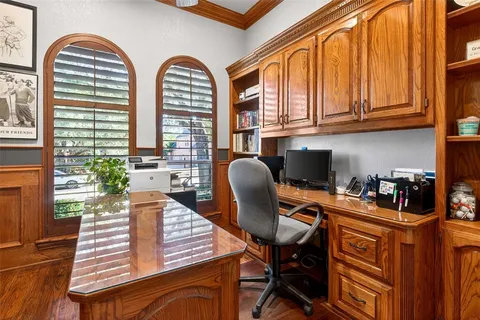 a view of a workspace with furniture and a window