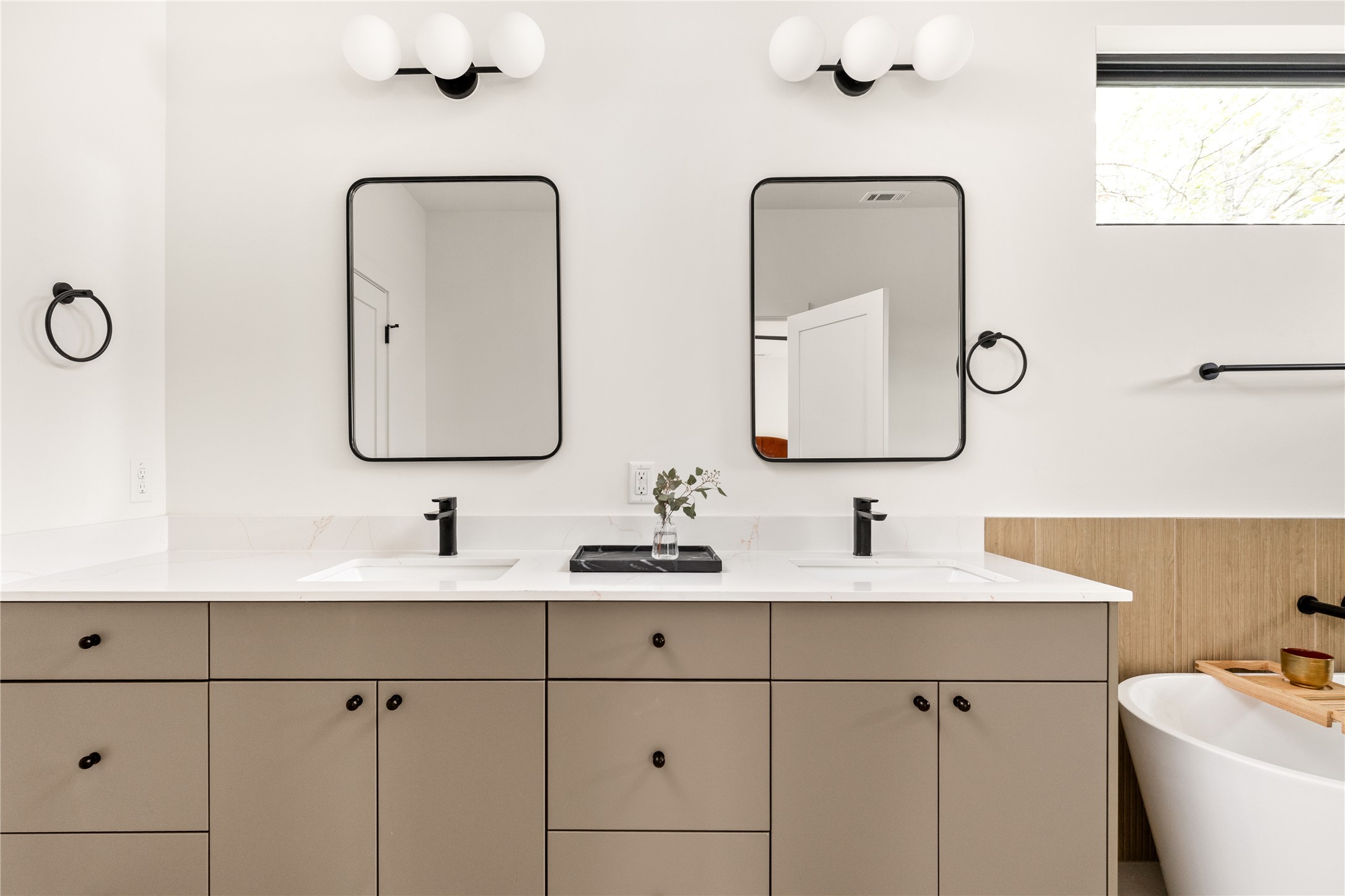 4414 South 1st Street, Unit 3 Austin, TX 78745 - Photo 24 of 39 Full bath with double vanity, a soaking tub, and wainscoting