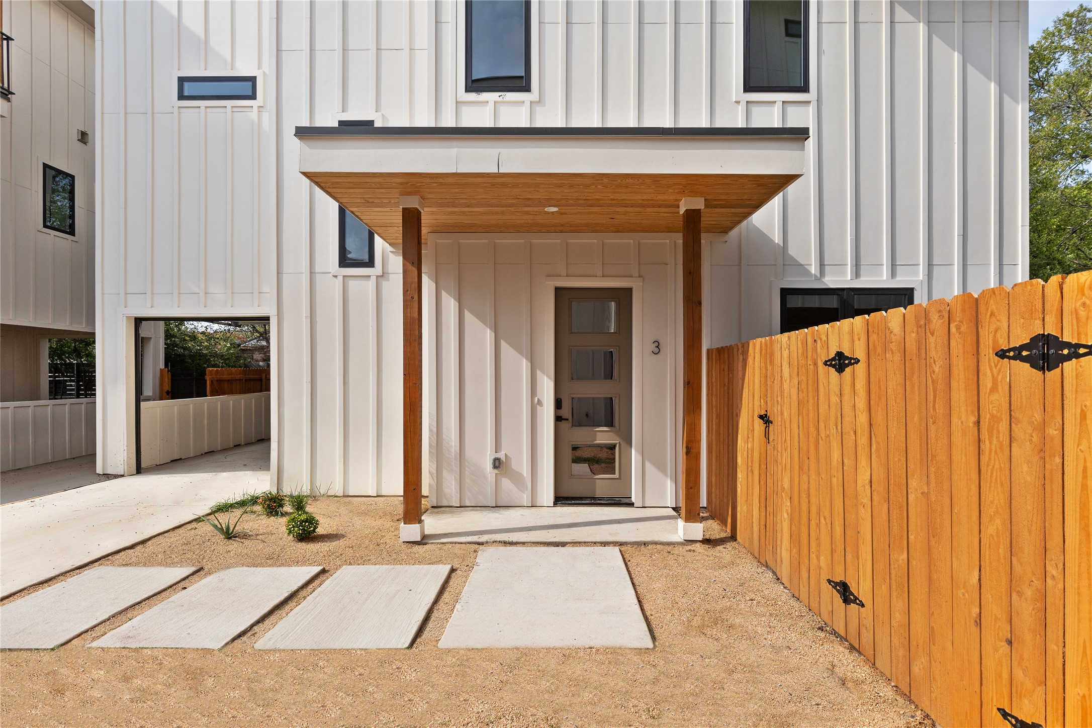 4414 South 1st Street, Unit 3 Austin, TX 78745 - Photo 29 of 39 Doorway to property featuring board and batten siding, covered porch, and a gate