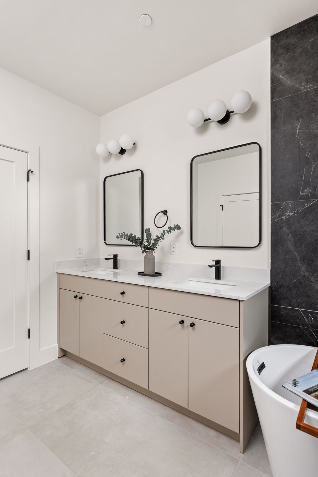 4414 South 1st Street, Unit 3 Austin, TX 78745 - Photo 34 of 39 Bathroom with a freestanding tub, double vanity, and tile walls