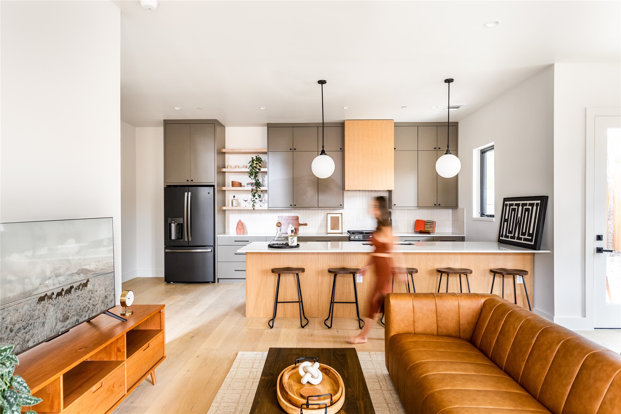 4414 South 1st Street, Unit 3 Austin, TX 78745 - Photo 6 of 39 Kitchen with open shelves, light countertops, fridge with ice dispenser, pendant lighting, and a kitchen bar