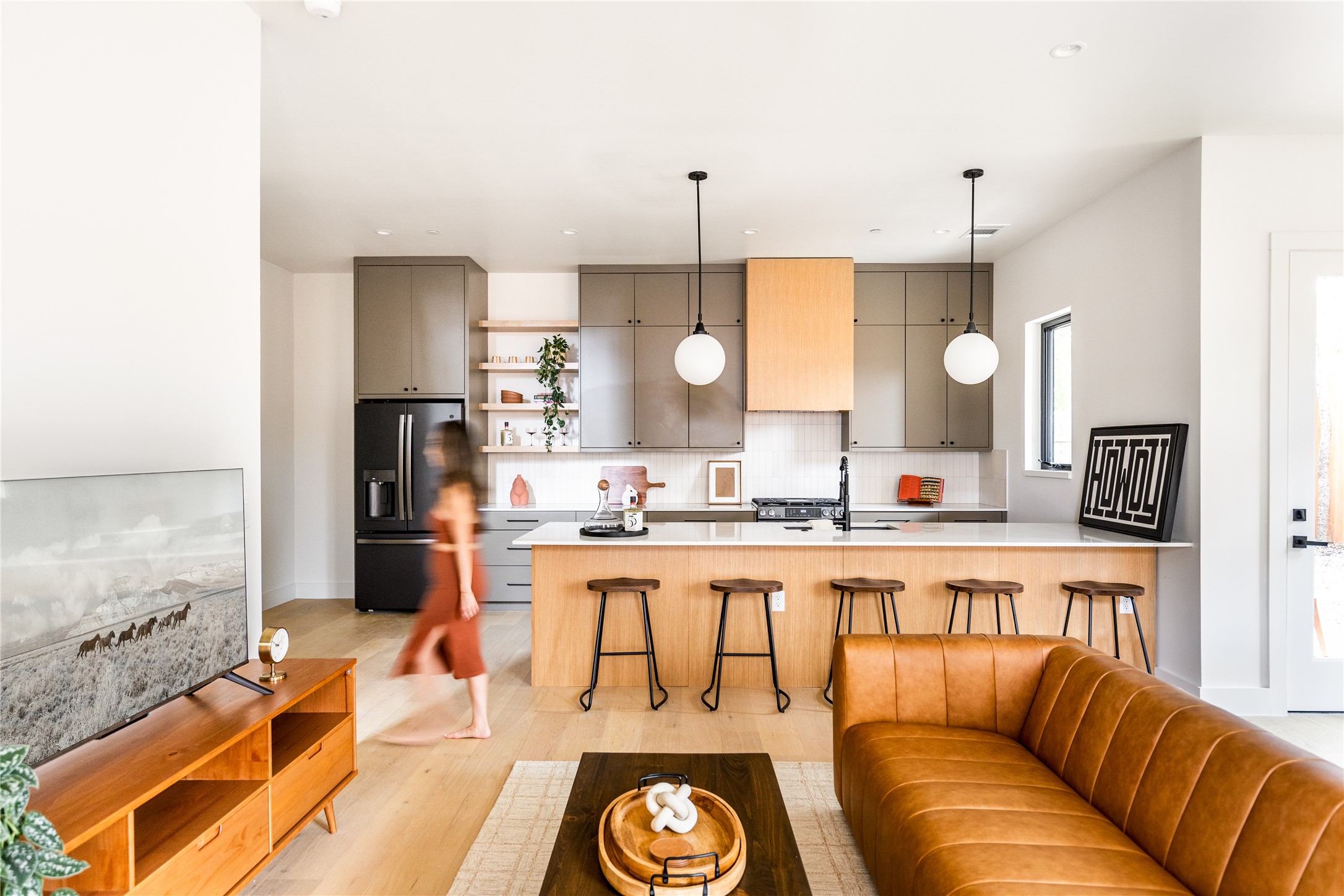 4414 South 1st Street, Unit 3 Austin, TX 78745 - Photo 7 of 39 Kitchen featuring open shelves, black fridge with ice dispenser, modern cabinets, a kitchen breakfast bar, and pendant lighting