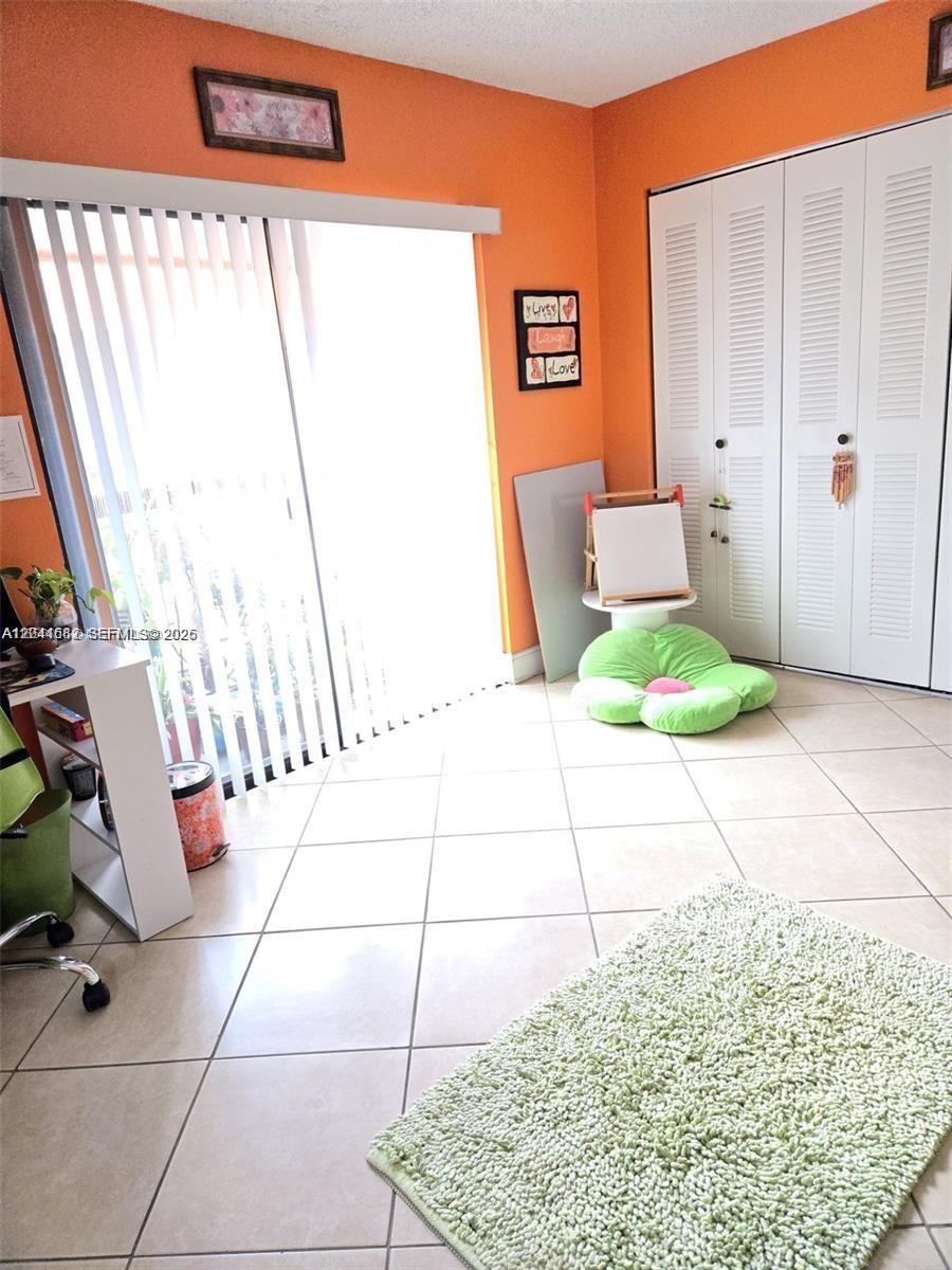 2174 West 60th Street, Unit 17205 Hialeah, FL 33016 - Photo 11 of 11 a living room with a rug