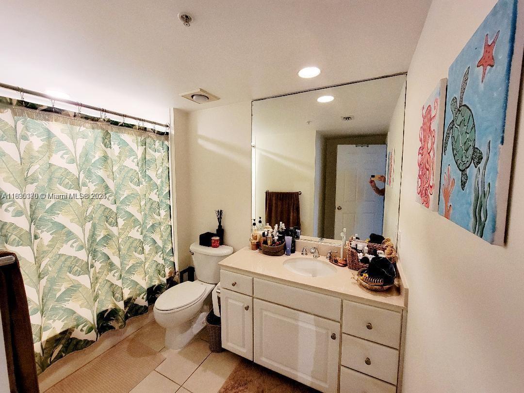 2000 North Bayshore Drive, Unit 226 Miami, FL 33137 - Photo 7 of 15 a bathroom with a sink mirror and a toilet