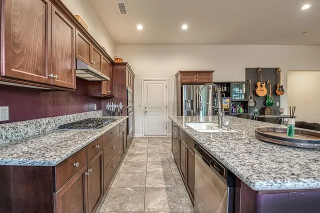 a kitchen with wooden cabinets and a stove top oven
