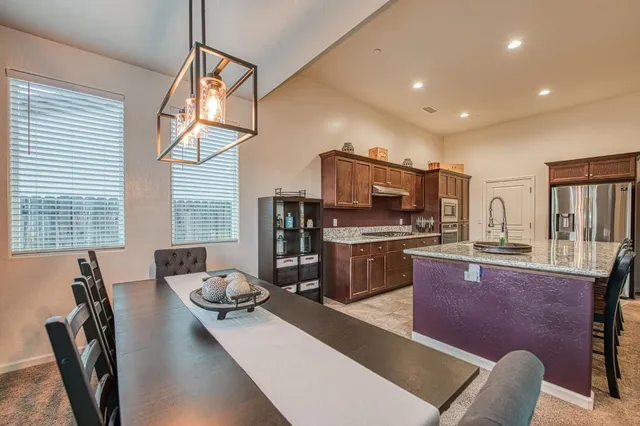 a living room with furniture kitchen view and a flat screen tv
