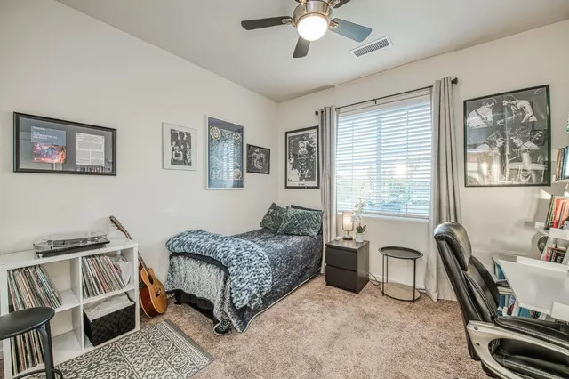 a bedroom with a bed and a television