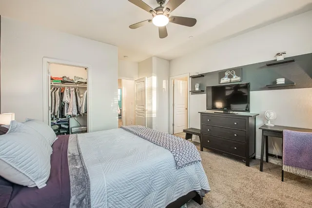 a bathroom with a tub a sink double vanity and window