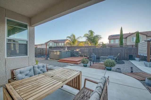 a view of a patio with couches table and chairs with wooden floor