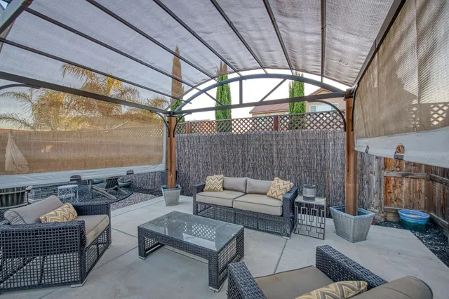 a backyard of a house with outdoor seating