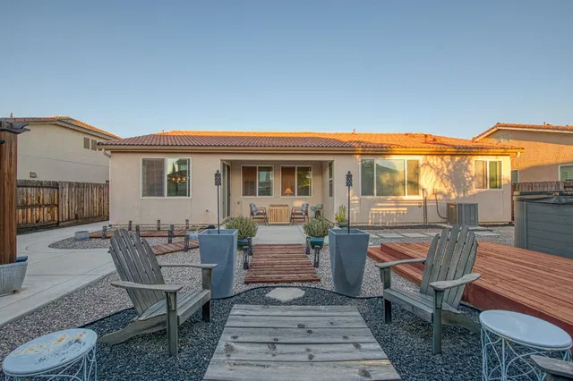 a view of a patio with a dining table and chairs with wooden floor